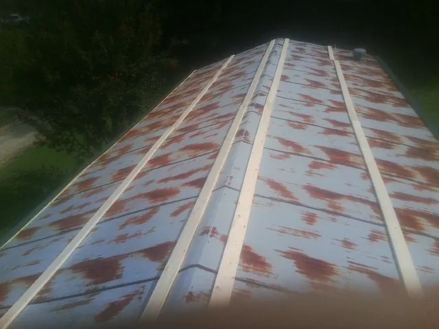 Rusted metal roof panels with new wood purlins before replacement — Storm Damage Roof Repair in Noblesville by Roofing Brothers