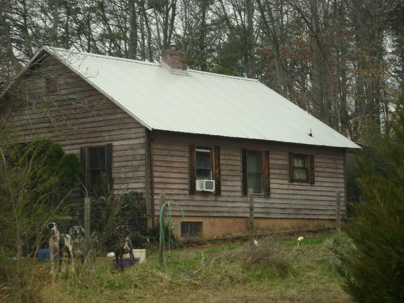 White metal roof on an old wood sided farmhouse, from a Metal Roof Installation job in Noblesville